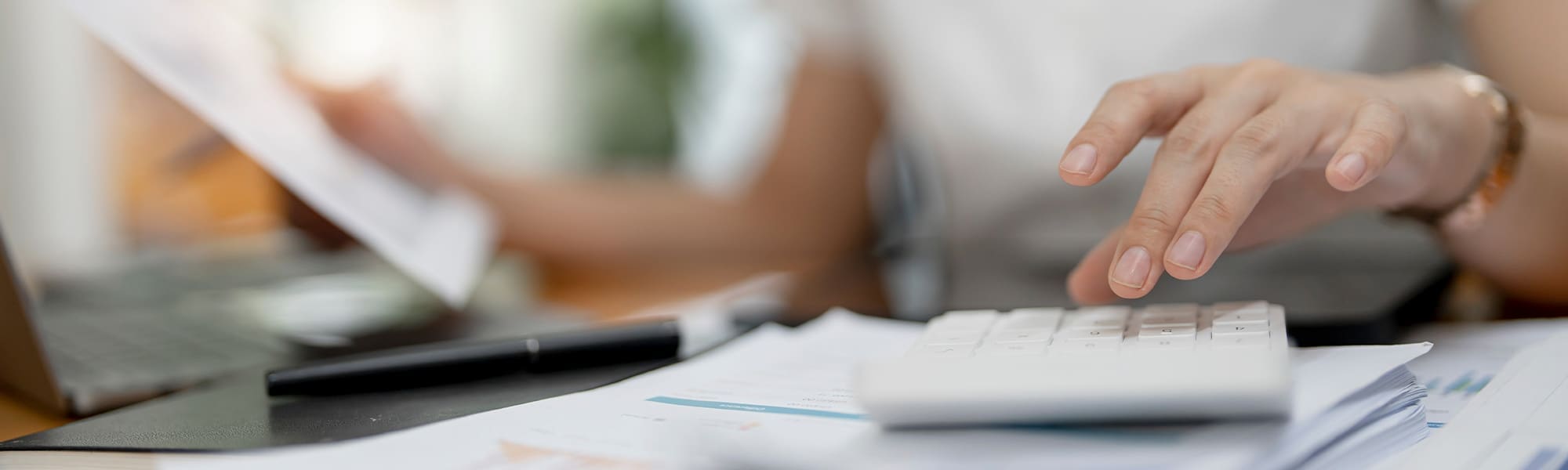 Economic Outlook of the Housing Market Featured Image Female accountant or banker making calculations on the housing market