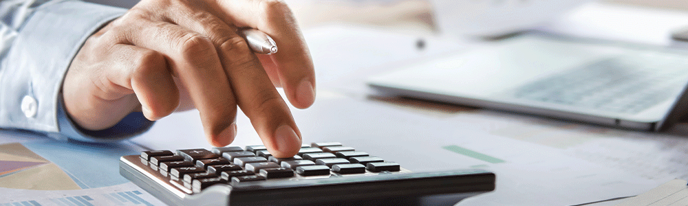 accountant working on desk using calculator for calculate finance report in office