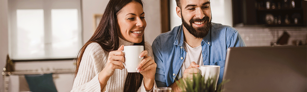 Happy couple communicating through computer home. Happy couple communicating through computer home.