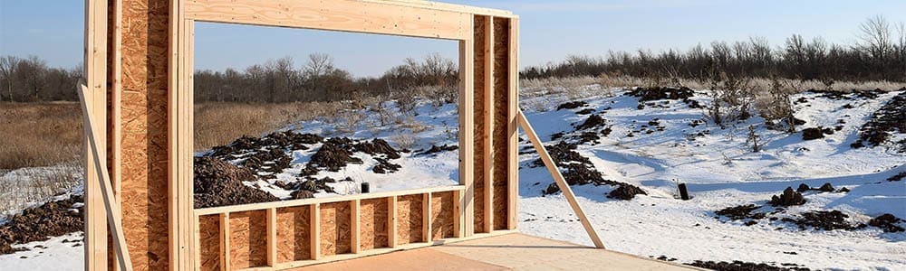 New Home House Construction Framing Lumber Builders Carpentry Craftsman with Snow New Home House Construction Framing Lumber Builders Carpentry Craftsman with Snow