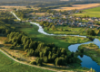 Aerial view. Small village. Blue winding river.