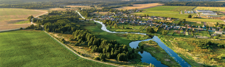 Aerial view. Small village. Blue winding river.