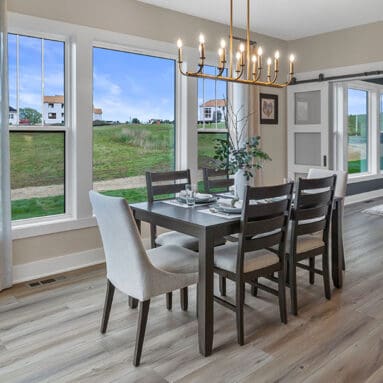 Parade of Homes model, The Lexi, dinning room with large picture windows looking to the backyard