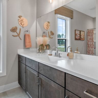 Parade of Homes model, The Lexi, secondary full bathroom features bright white counters with contrasting dark wood lowers.