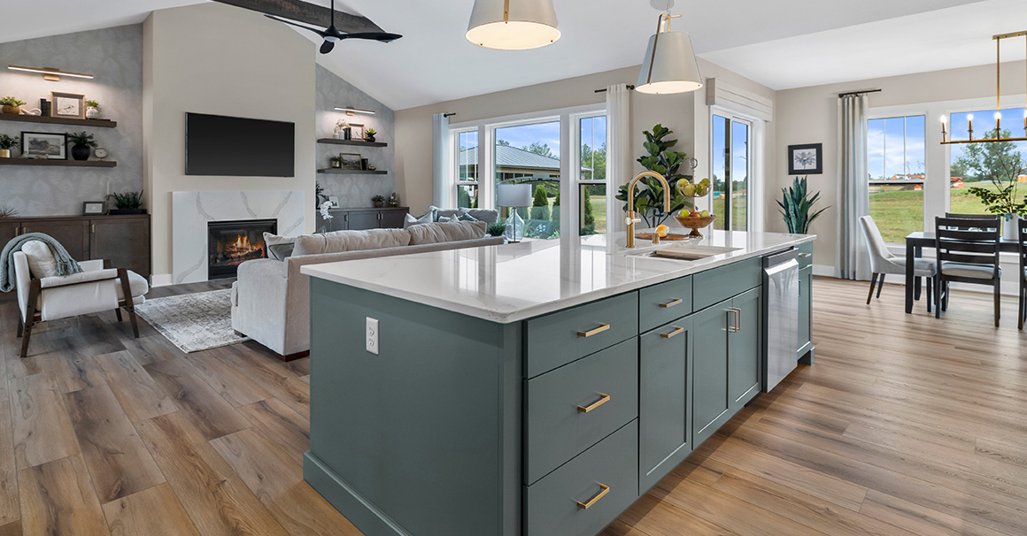 Parade of Homes model, The Lexi, kitchen featuring bright white counter tops, dark green grey lowers, and wood uppers. This angle looks at the great room.