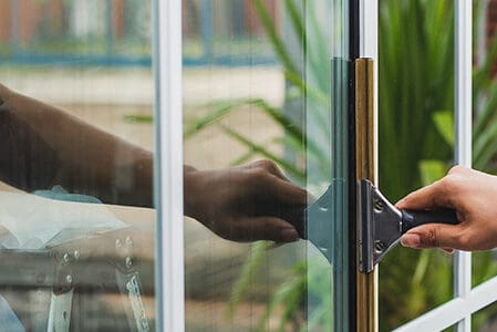 Cleaning home windows with a squeegee